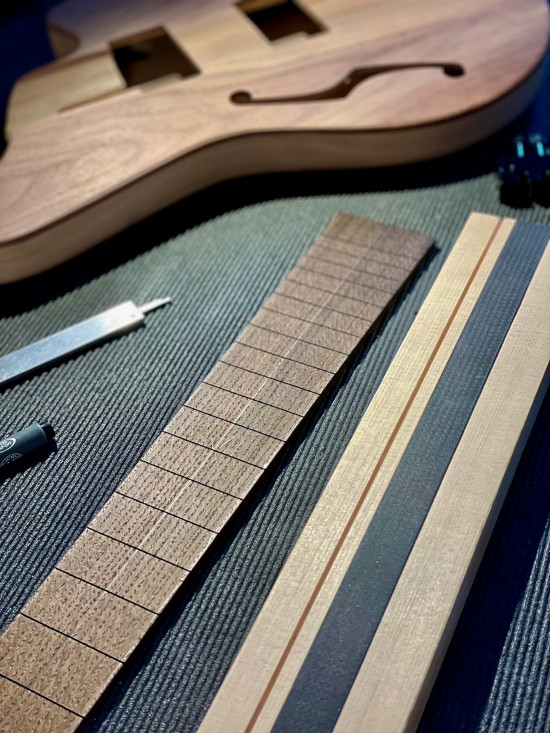 Close-up of unassembled Gemini carbon fiber D-Tube components for the JAFmaster guitar